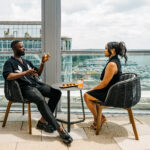 Couple drinking at the roof bar, laughing