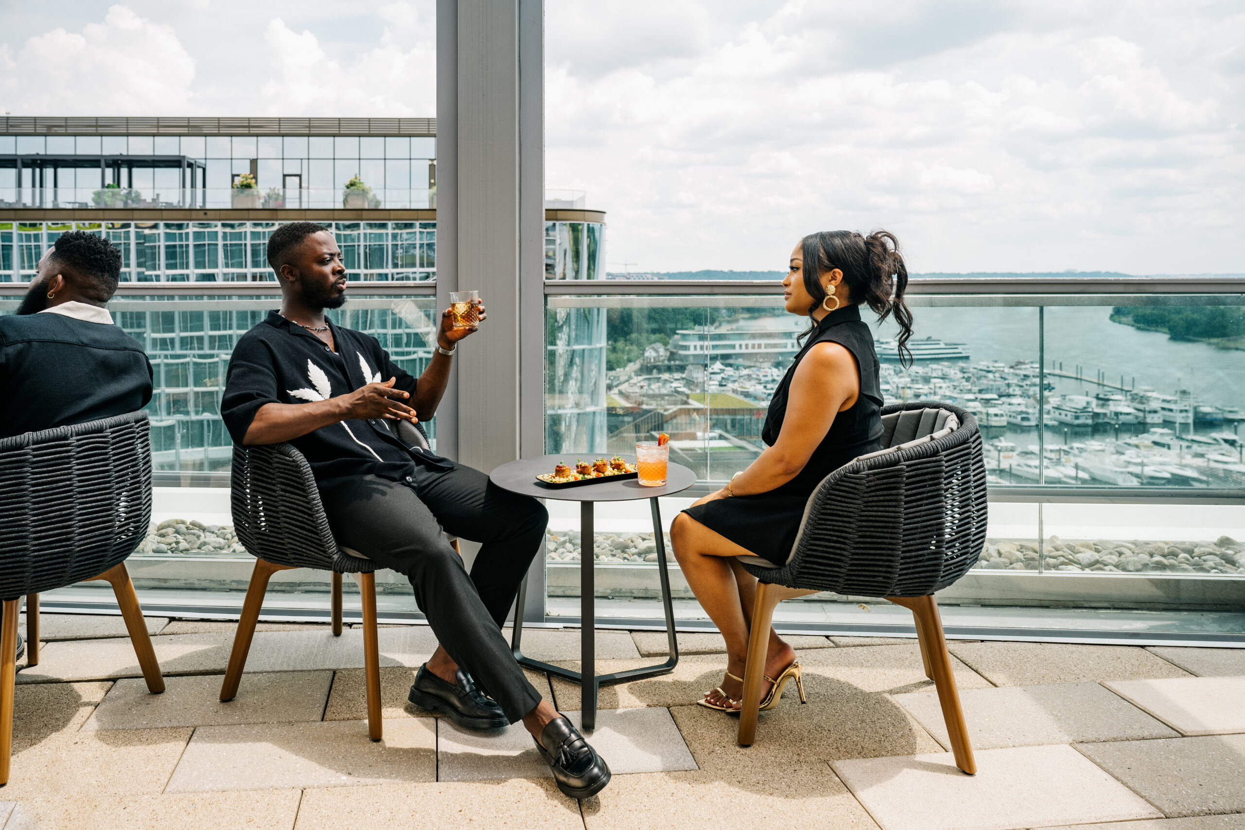 Couple drinking at the roof bar, laughing